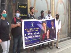 
      
      Fans gather outside Mannat with 'welcome home Aryan Khan' poster
      
      