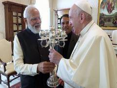 
      
      PM Modi gifts silver candle stand, book on India's commitment...
      
      