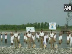
      
       ITBP personnel perform yoga with dogs in tow
      
      