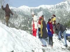 
      
      Tourists play with snow, dance, enjoy themselves at J-K's...
      
      