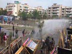 
      
      Protesting farmers try to break through police barricades at...
      
      