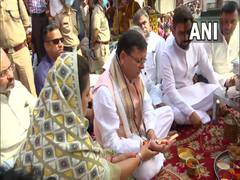 
      
      Dhami along with his wife offer prayers in Haridwar
      
      