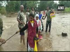 
      
      CRPF personnel form human chain to help locals cross flooded...
      
      