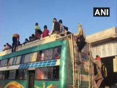 
      
      Coronavirus lockdown: Migrants walk on foot, board buses at...
      
      