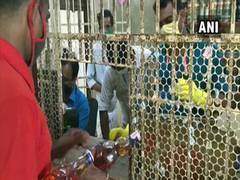 
      
      Queues outside liquor shops in Kerala of people with e-token
      
      