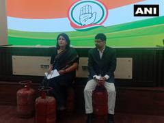 
      
      Congress leaders sit on LPG cylinders to address a press...
      
      