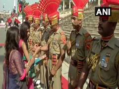 
      
      Women tie "rakhis" to BSF jawans at Attari-Wagah Border
      
      