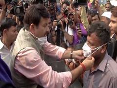 
      
      Delhi BJP chief Manoj Tiwari distributes masks as protest...
      
      