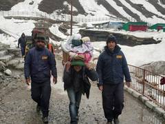 
      
      Kedarnath: SDRF personnel help devotees cross snow laden paths
      
      