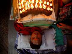 
      
      Devotees thank gods by covering body with cow dung, lit...
      
      
