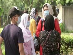 
      
      Afghan nationals gather outside Aussie embassy in New Delhi...
      
      