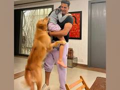 
      
      Akshay Kumar adorably hugs his daughter, pet dog 
      
      