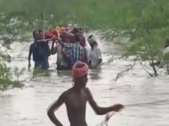 
      
      Virudhanagar: Villagers carry body of person through flooded river
      
      