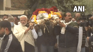 
      
      PM Modi pays floral tribute, carries mortal remains of his mother
      
      