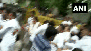 
      
      Rahul Gandhi sits on road in protest
      
      