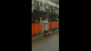 
      
      Karnataka man wipes rainwater from cutouts of PM Modi
      
      