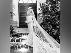 
      
      Hailey Baldwin paired her wedding gown with sneakers for...
      
      