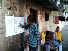 
      
      No work due to lockdown, painter writes 'Help Us' on wall of house
      
      