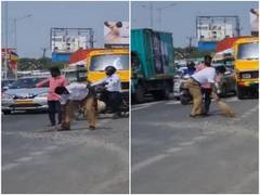 
      
      Video of traffic cop sweeping pebbles off busy road goes viral
      
      