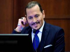 
      
      Johnny Depp laughs in court
      
      