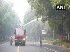 
    Delhi: NDMC Trucks sprinkle water on Lodhi road to settle dust amid rising AQI
    