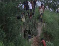 
      
      Villagers come together to stop floodwater from entering...
      
      