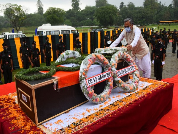 Uttarakhand CM Trivendra Singh Rawat  laid a flower wreath on the mortal remains of a soldier on Tuesday. [Photo/ANI]