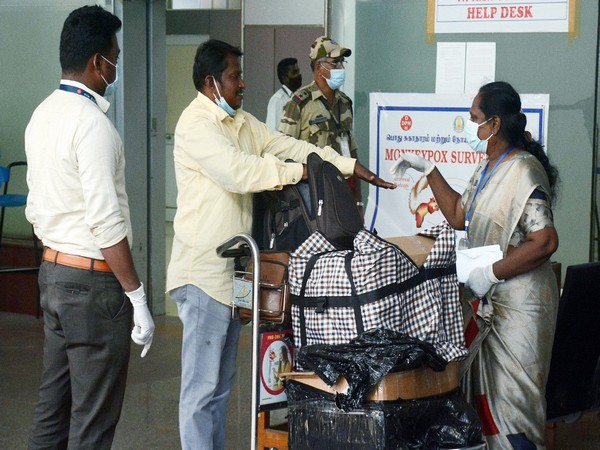 Health workers inspect passengers arriving from high risk countries for MonkeyPox symptoms (File Photo/ANI)