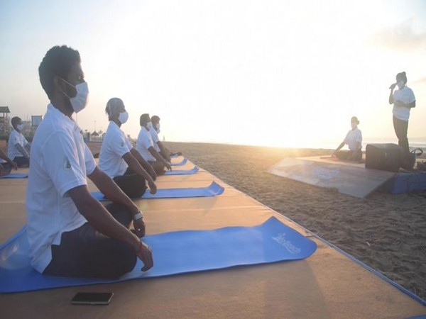 Recovered COVID-19 patients practicing Yoga at the Golden Beach. (Photo/ANI)