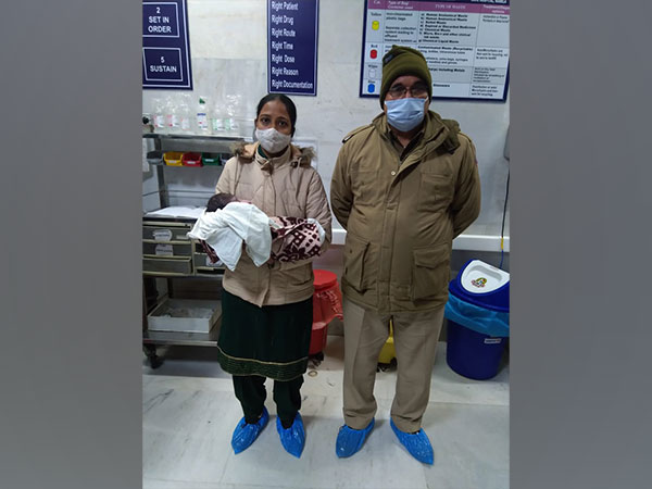 Rescued baby with Alipur police staff in hospital. (ANI/photo)