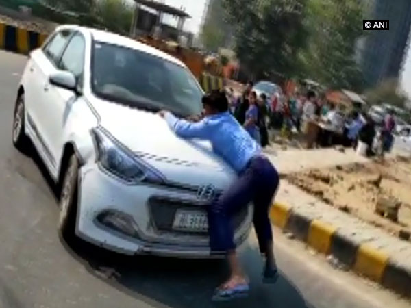 Visuals of man who grabbed a car bonnet and was dragged 2 km in Indirapuram, Ghaziabad on Wednesday.
