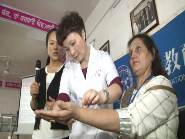 A Chinese expert conducting training programme on acupuncture at DNKHEC in Ludhiana, Punjab. Photo/ANI