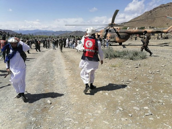 People carry injured to a helicopter following a massive earthquake, in Paktika Province, Afghanistan, June 22, 2022, in this screen grab taken from a video. (Photo Credit: IFRC Twitter)