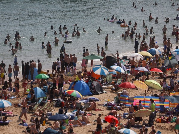 People and children enjoy the hot weather at Bournemouth Beach, as a heat wave reaches the country, in Bournemouth, Britain (Photo Credit: Reuters)