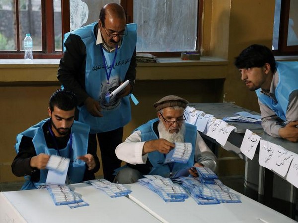 Afghan election commission workers count ballot papers of the presidential election in Kabul on Saturday