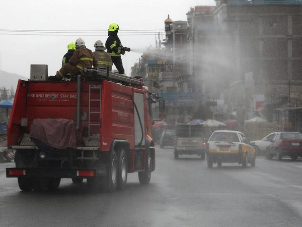 A vehicle spraying disinfectant along a street to prevent the spread of the coronavirus in Kabul