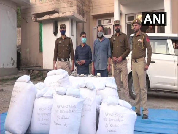 Visual of two accused held with seized contrabands in J-K's Tikri