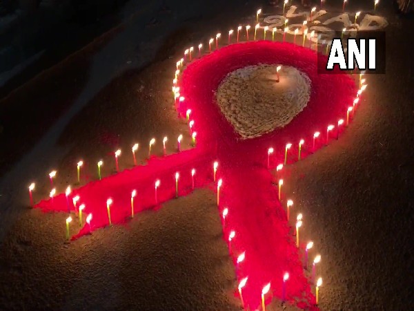 Sex workers and AIDS patients light up candles on eve of World AIDS Day (Photo/ANI)