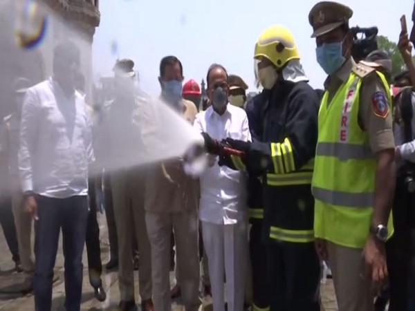 Telangana Home Minister Mahmood Ali disinfecting Charminar in Hyderabad on Sunday. Photo/ANI