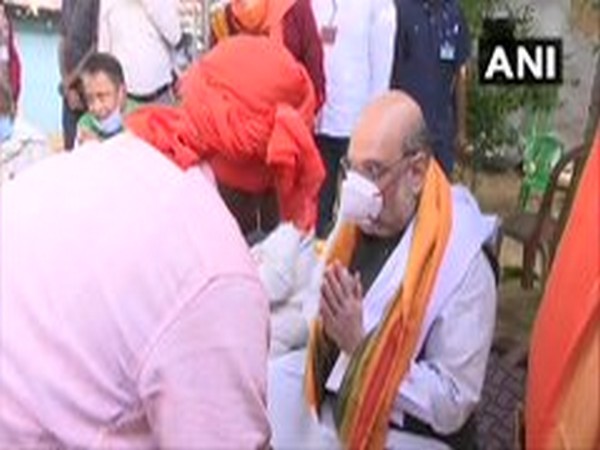Union Home Minister Amit Shah meets a villager in West Bengal on Thursday. (ANI/Photo)