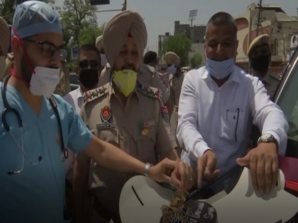 Doctor, cops and others celebrating the birthday of Civil Lines SHO in Amritsar on Friday. Photo/ANI