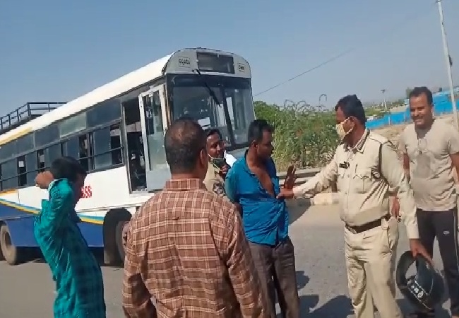 Police nabbing the accused who stole the bus in Andhra Pradesh. 