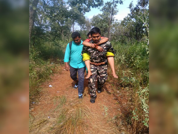 A visual of the constable carrying the woman on way to Tirumala temple in Andhra Pradesh.  