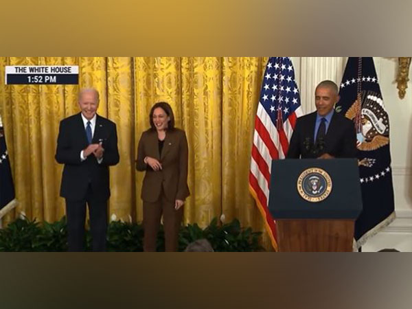 Former United States President Barack Obama standing alongside current President Joe Biden and Vice President Kamala Harris.