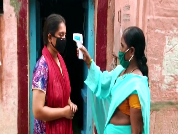 A villager in Ghatne gets her temperature checked. (Photo/ANI)