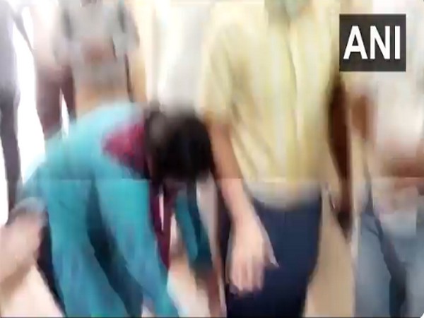 Famil members of COVID patients touching the feet of the CMO. (Photo/ANI)