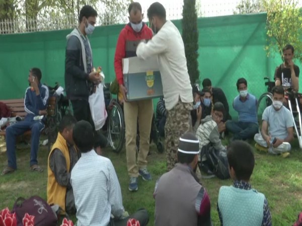 Specially-abled enjoying themselves in Srinagar's Tulip garden on Monday. (ANI)
