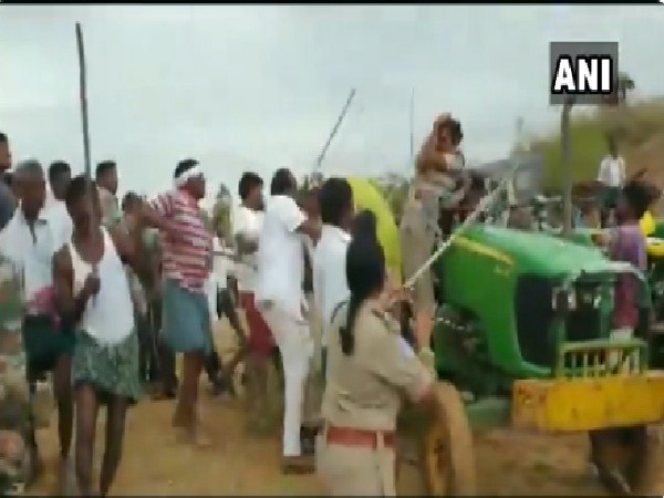 TRS workers allegedly beating women forest guard in Asifabad, Telangana on June 30. Photo/ANI