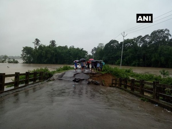 A bridge on Doomdooma-Baghjan road collapsed due to incessant rain in Tinsukia, Assam. (Photo/ANI)