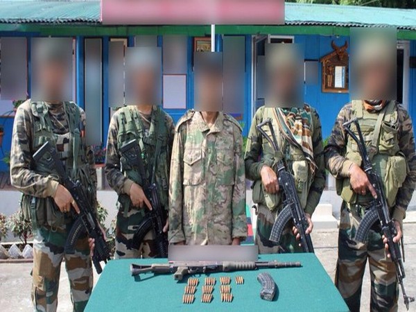 Assam Rifles jawans with the arrested ULFA (I) cadre and seized arms and ammunition. Photo/ANI